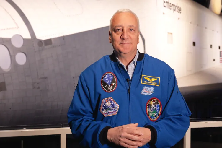 Mike Massimino, Senior Advisor of Space Programs at the Intrepid Museum, standing in front of the Space Shuttle.