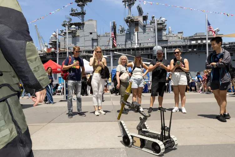 A crowd enjoying interactive activities with the Mass Rover on Pier 86 during Fleet Week.