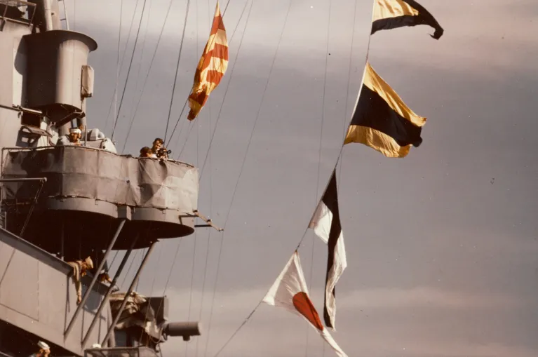 An archival photo of the Intrepid's island with flags